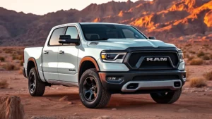 Professional photograph of a white 2023 Ram 1500 Rebel truck parked on rocky desert terrain with mountains in background, showing aggressive front grille design and all-terrain tires, golden hour lighting, clean commercial photography style