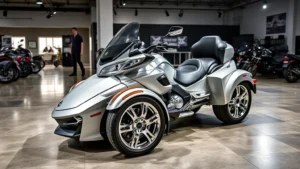 Professional three-wheeled trike motorcycle parked in modern dealership showroom with polished concrete floor, dramatic studio lighting highlighting chrome details and paint finish, salesperson in background